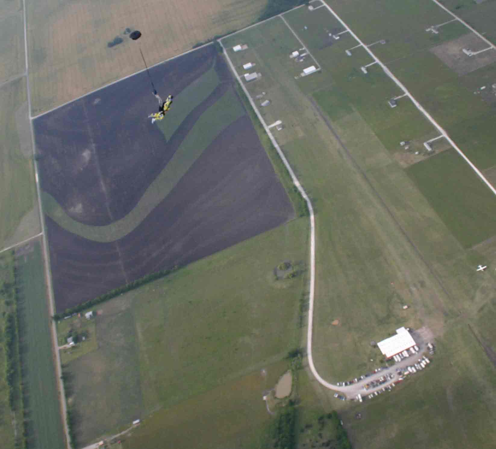 This is Skydive Dallas from the air with me just opening over it. You land in the hook of the question mark.